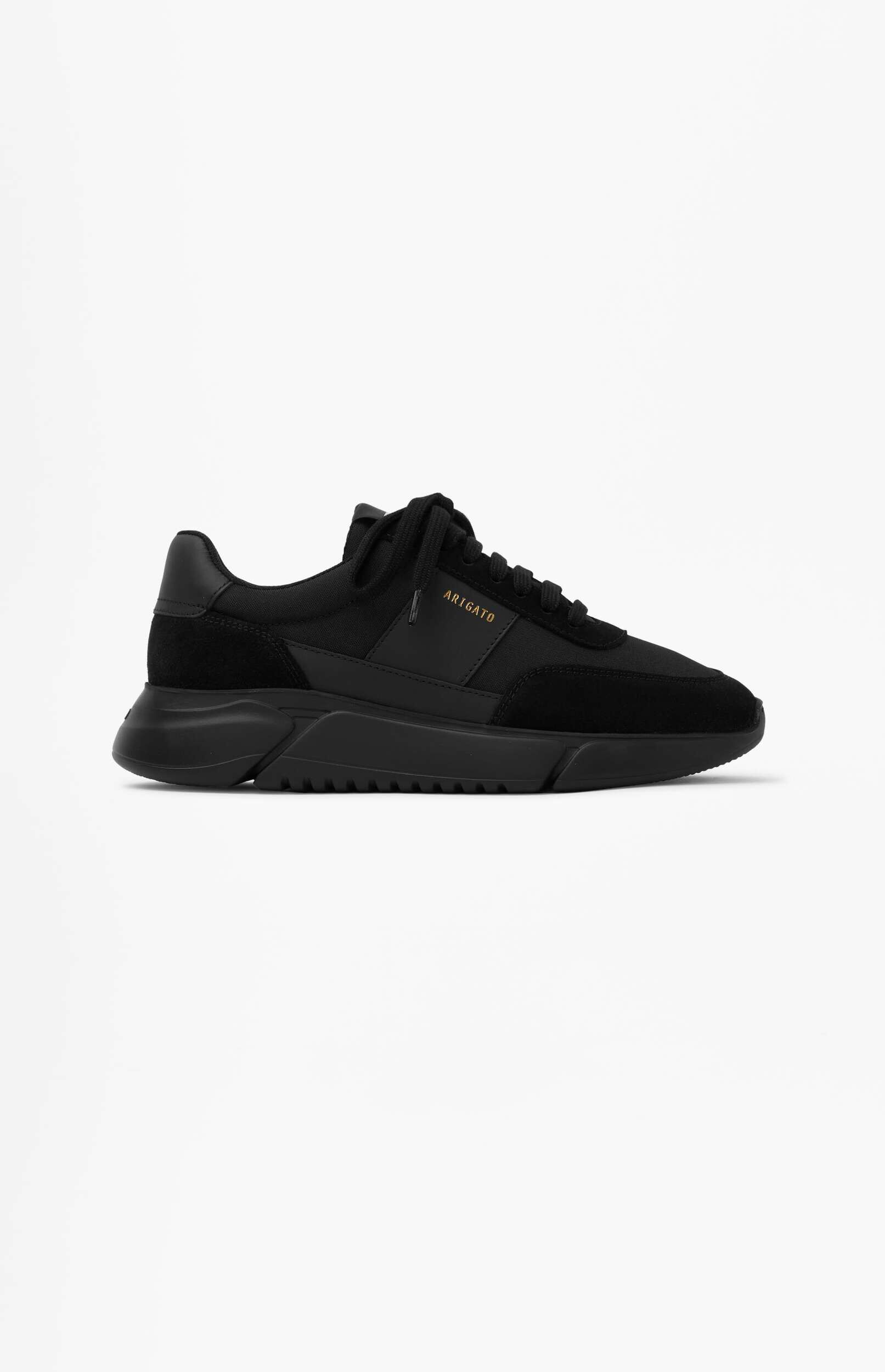 A single black athletic sneaker with a thick black sole and gold 'ARIGATO' branding on the side, displayed on a white background.