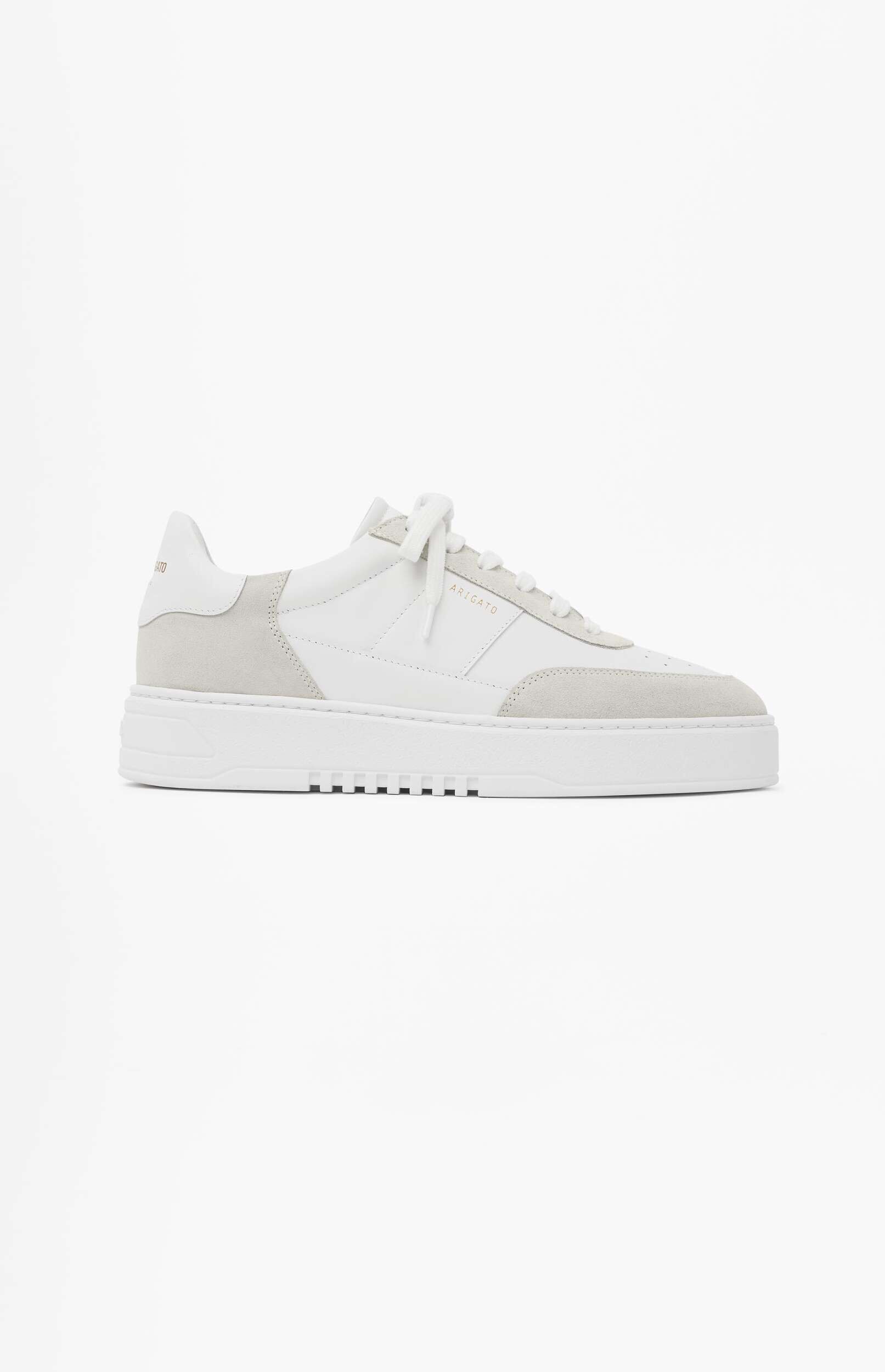 A white and light gray suede sneaker with white laces, featuring the 'ARIGATO' brand name on the side, displayed against a plain white background.