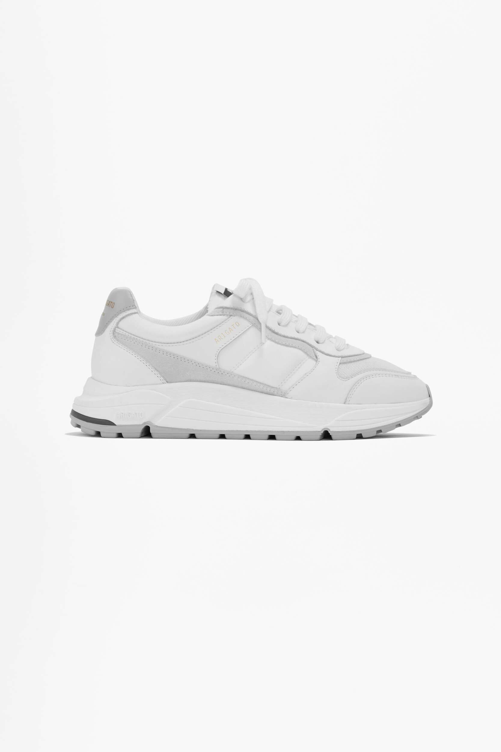 A clean white and light grey Axel Arigato Genesis sneaker, viewed from the side, on a plain white background.