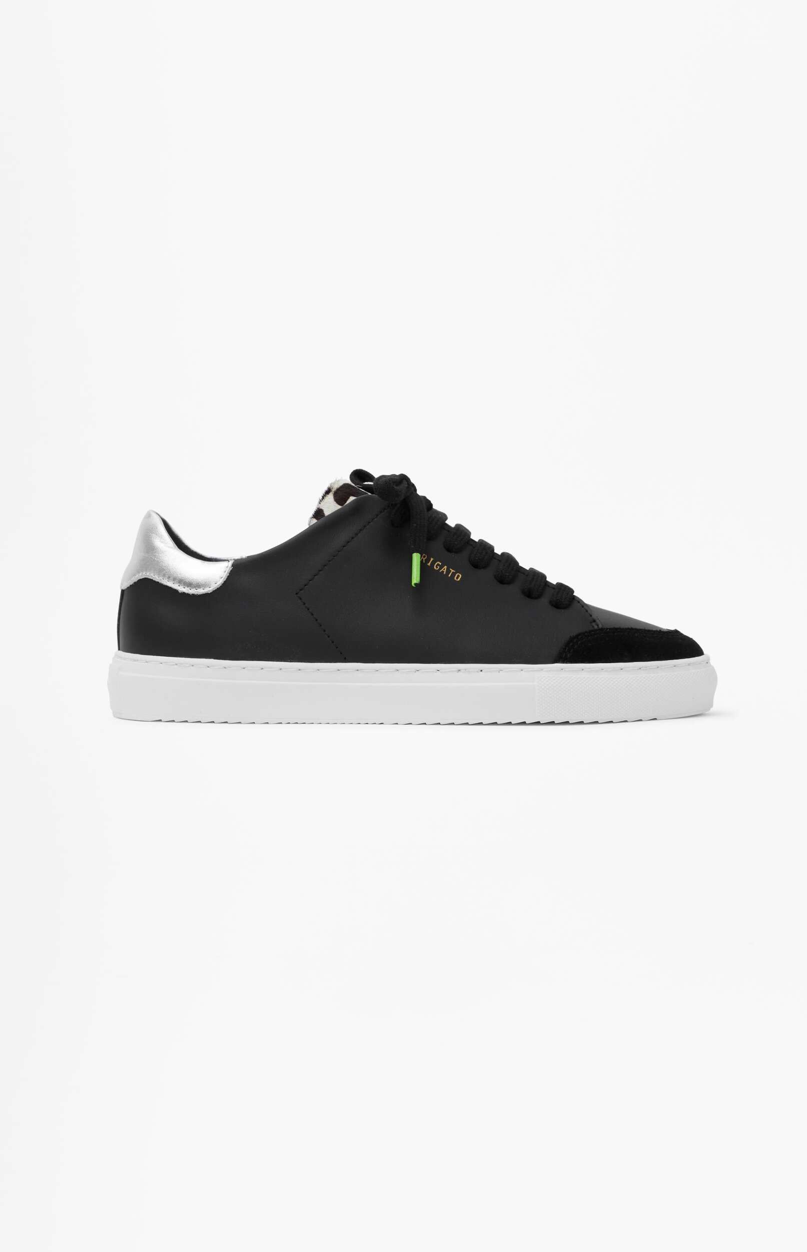 A black leather sneaker with a white sole, silver heel tab, and subtle leopard print detailing on the tongue, shown on a plain white background.
