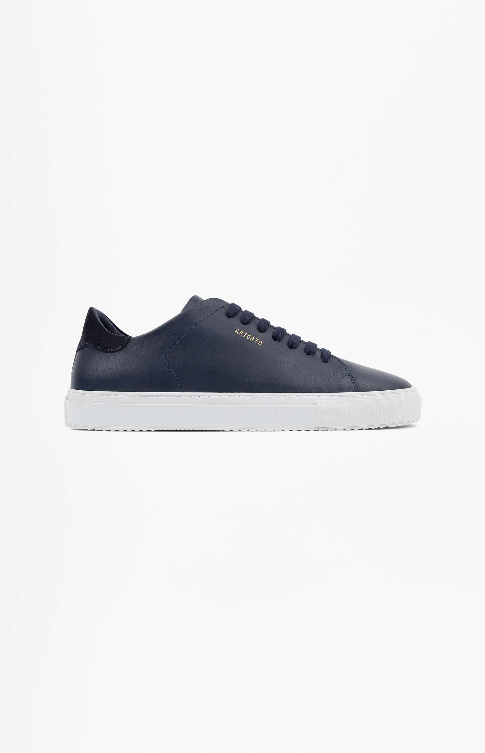 A minimalist dark blue leather sneaker with a white rubber sole and dark blue laces, featuring the gold 'ARIGATO' logo on the side. The shoe is presented on a plain white background.