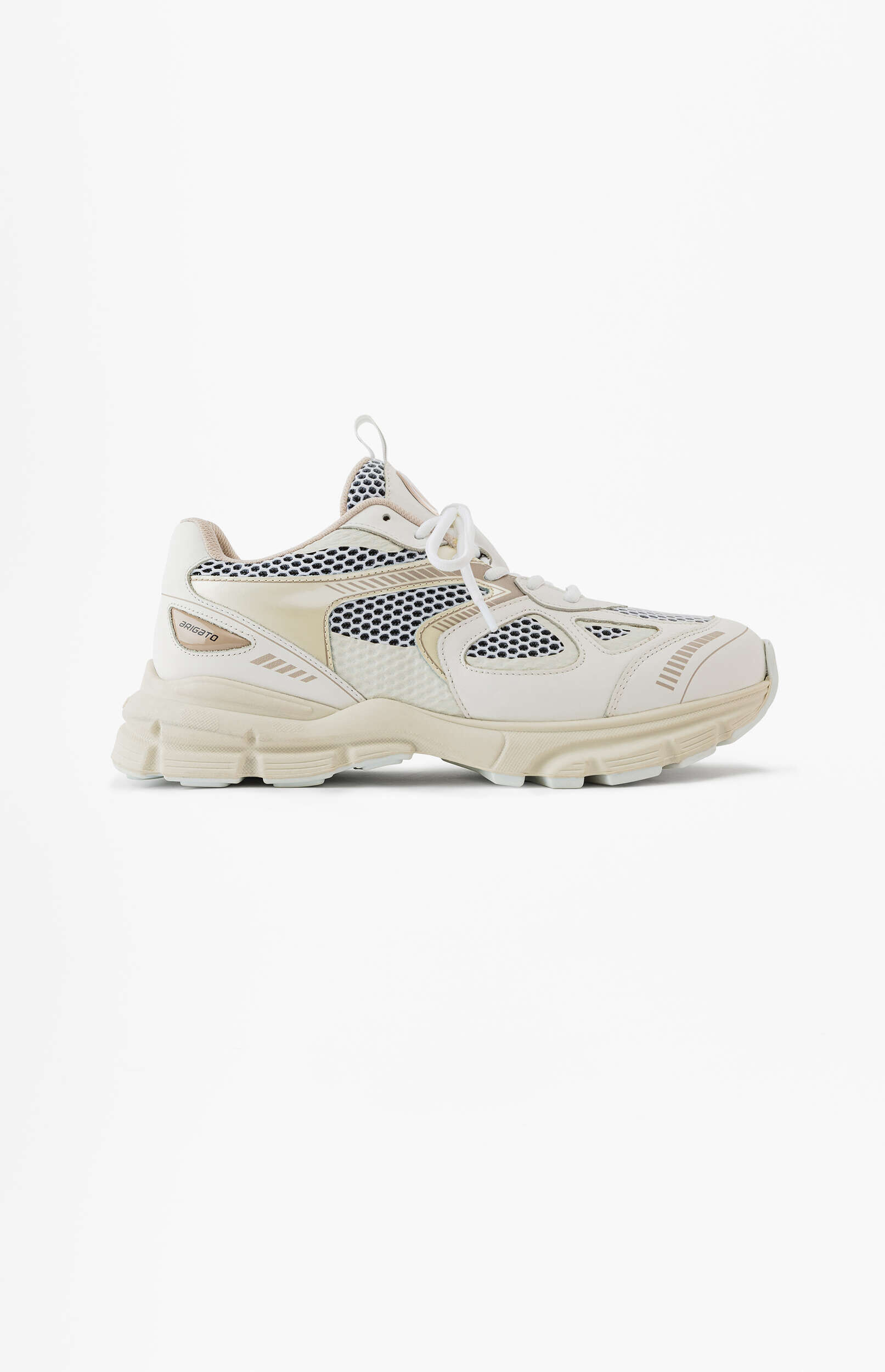 A light cream-colored athletic sneaker with a chunky sole, mesh panels, and synthetic leather overlays. The brand 'ARIGATO' is visible on the side. The shoe is displayed against a white background.