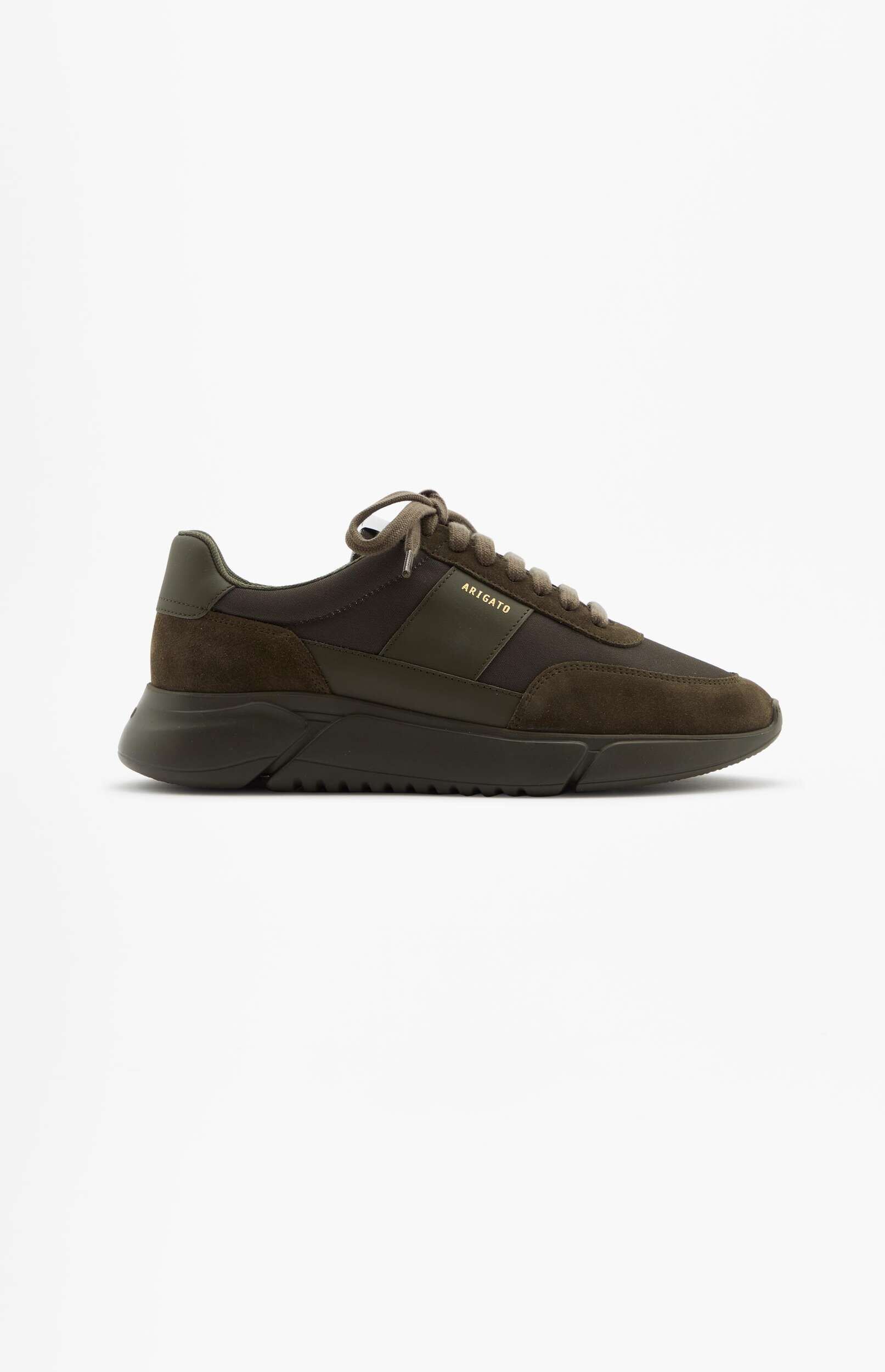 A single olive green and dark brown sneaker with a thick sole, featuring suede and fabric textures, and the 'ARIGATO' logo visible in gold on the side, displayed on a clean white background.