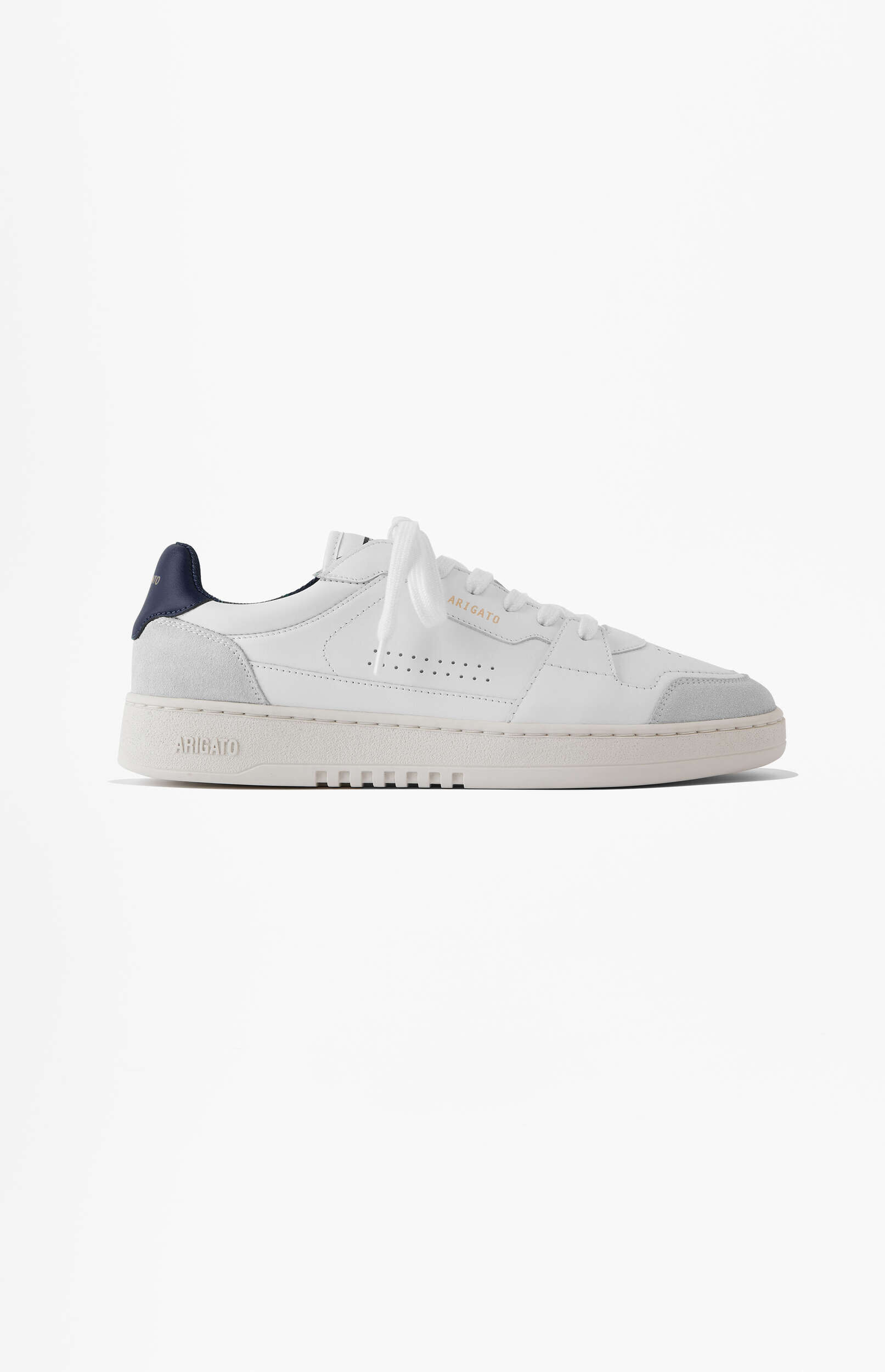 A clean white leather and suede sneaker from the brand ARIGATO, featuring light grey suede panels, a dark blue heel tab, and side perforations, presented on a plain white background.