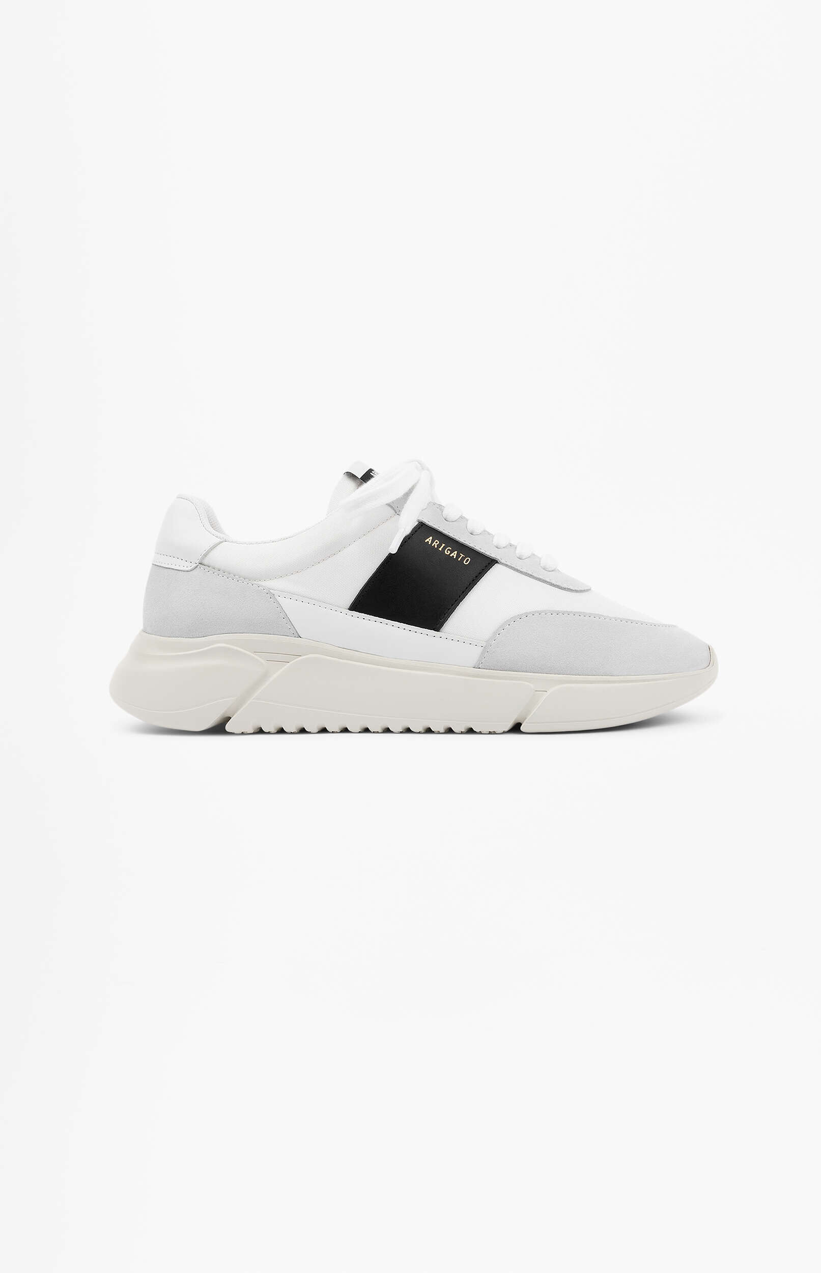 A white and light grey sneaker with a black stripe featuring "ARIGATO" in gold text on the side, displayed against a clean white background. The shoe has a thick, sculpted white sole.
