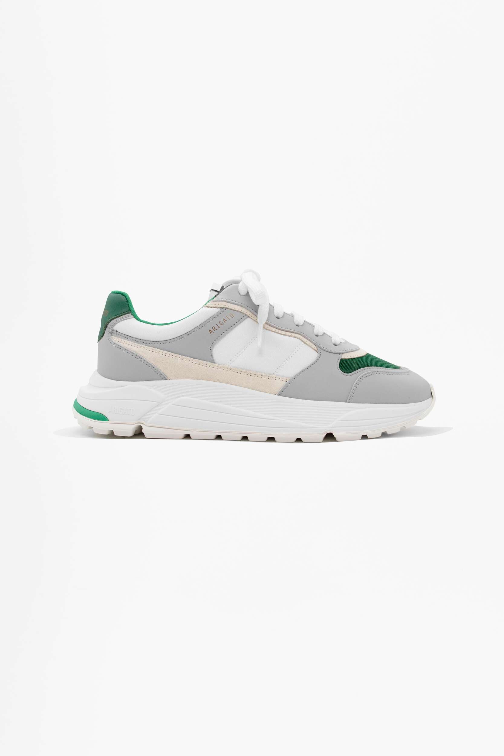 A single light grey, white, and cream ARIGATO sneaker with dark green accents and white laces, featuring a chunky sole, displayed on a plain white background.
