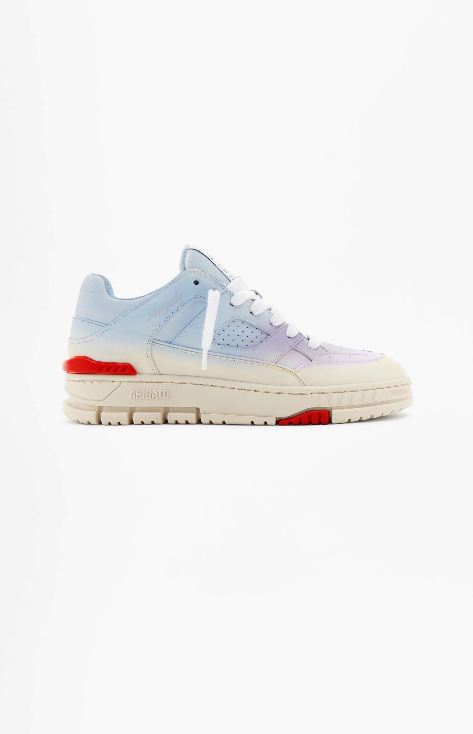 A light blue and purple gradient sneaker with white laces and a cream sole, featuring red accents and 'ARIGATO' branding on the side, displayed against a white background.