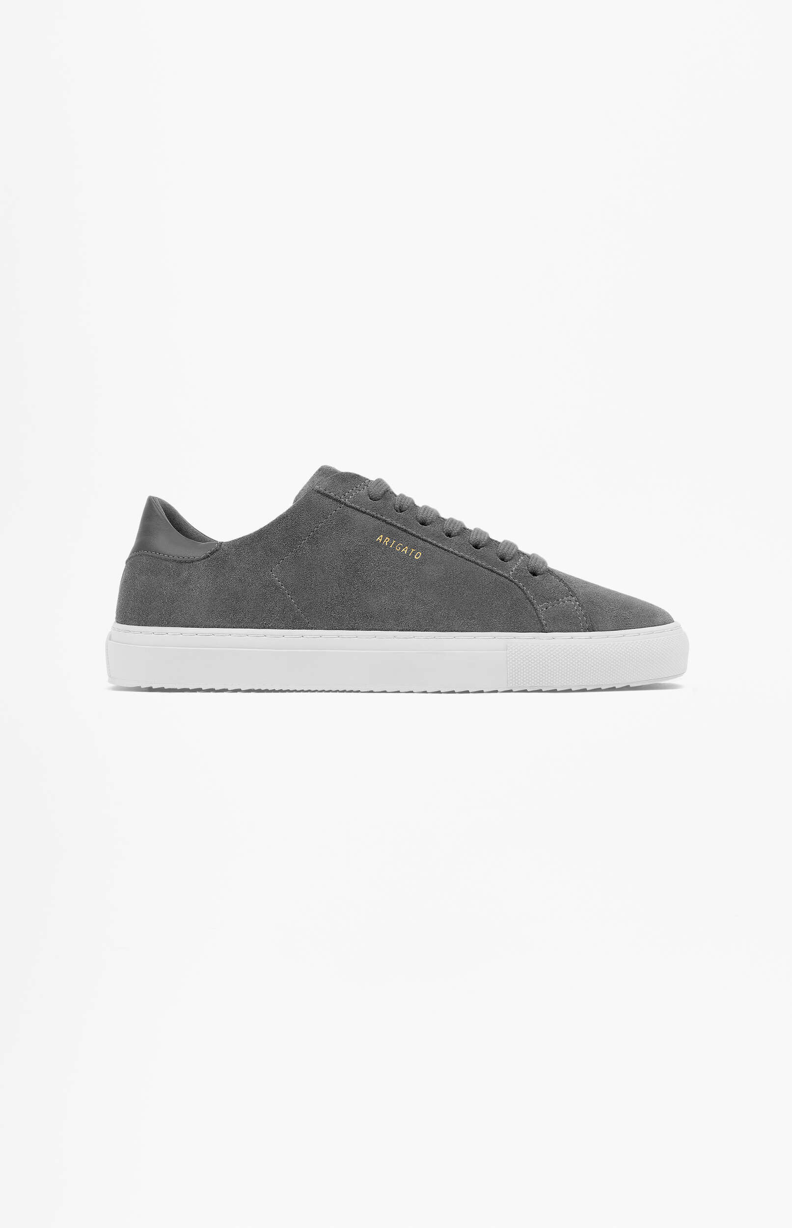 A single dark grey suede sneaker with white soles and 'ARIGATO' in gold lettering on the side, viewed from the side on a white background.