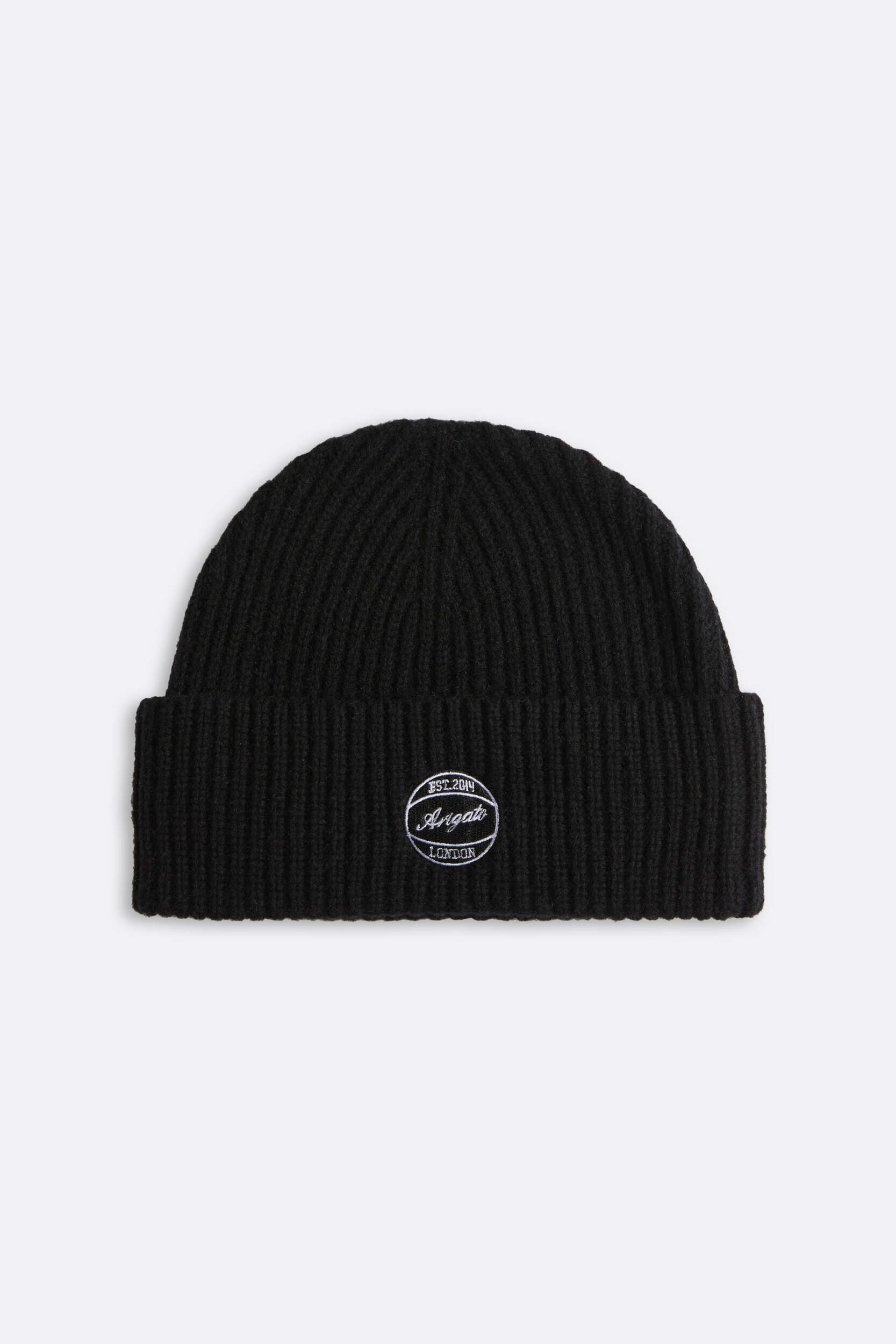 A black ribbed knit beanie with a white embroidered logo. The circular logo features 'EST. 2014' at the top, 'Arigato' in the center, and 'LONDON' at the bottom. The beanie is shown against a plain light gray background.