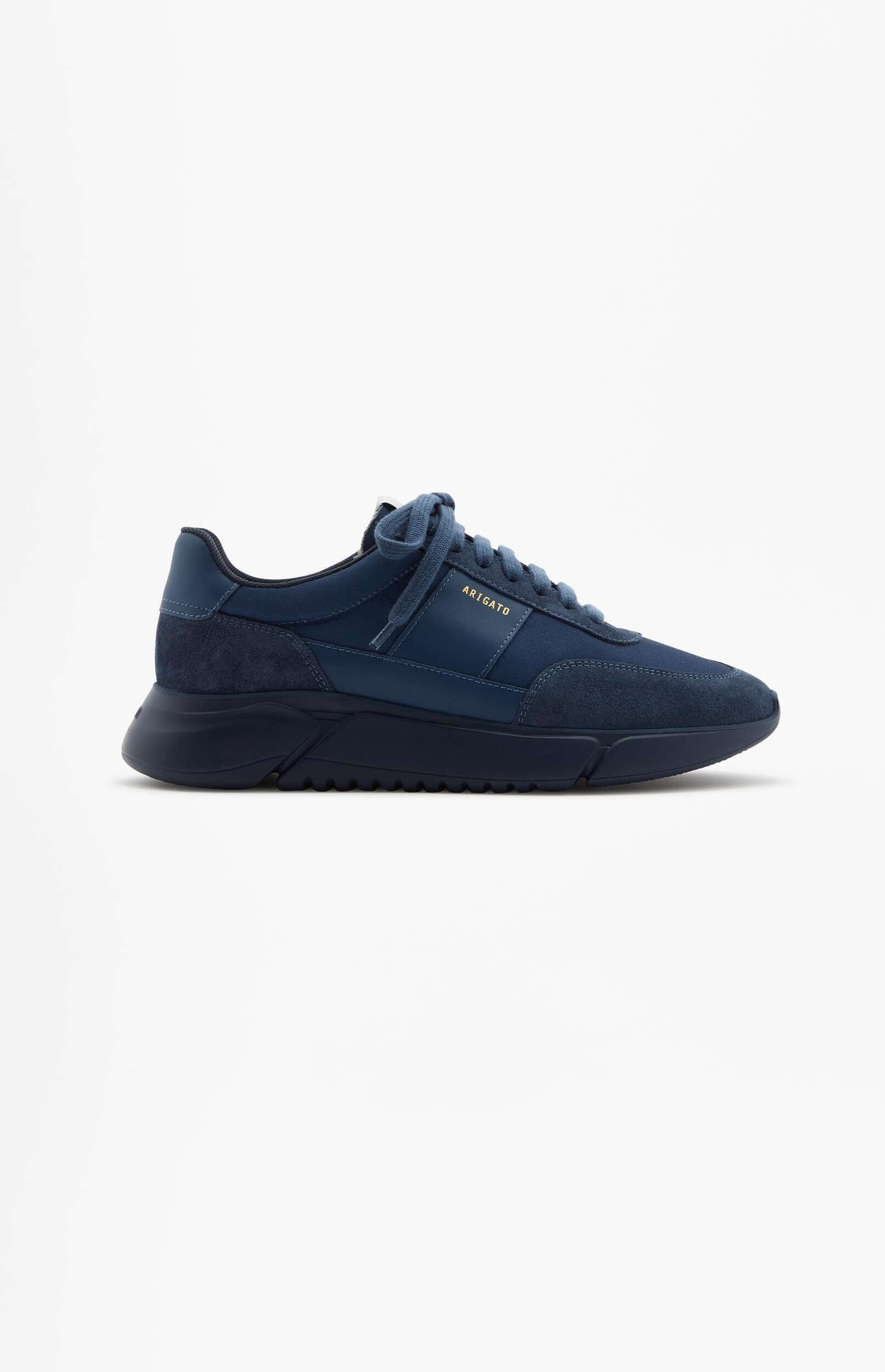 A single navy blue Axel Arigato sneaker, featuring mixed textures including suede, with gold 'ARIGATO' branding visible on the side, presented on a white background.