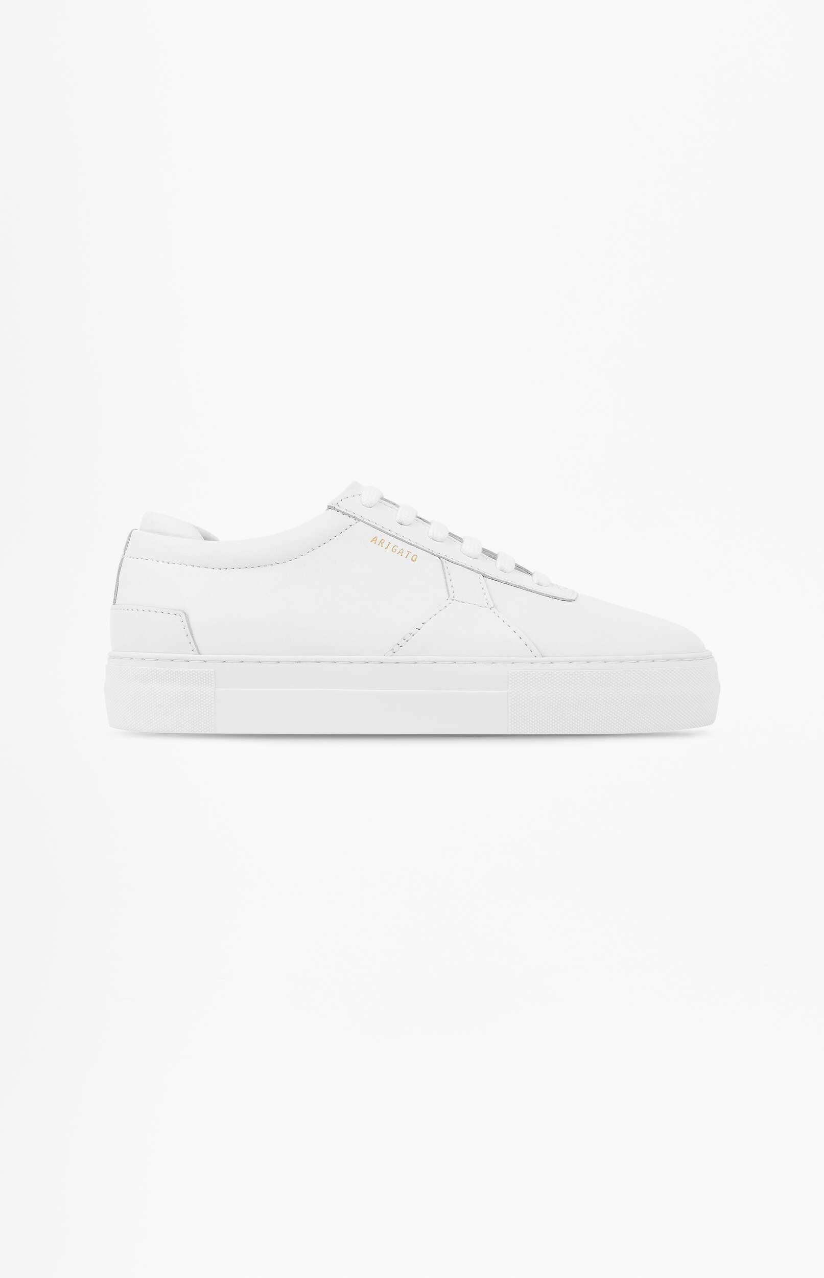 A clean, white leather low-top sneaker with a thick white sole and subtle gold 'ARIGATO' branding on the side, presented on a plain white background.