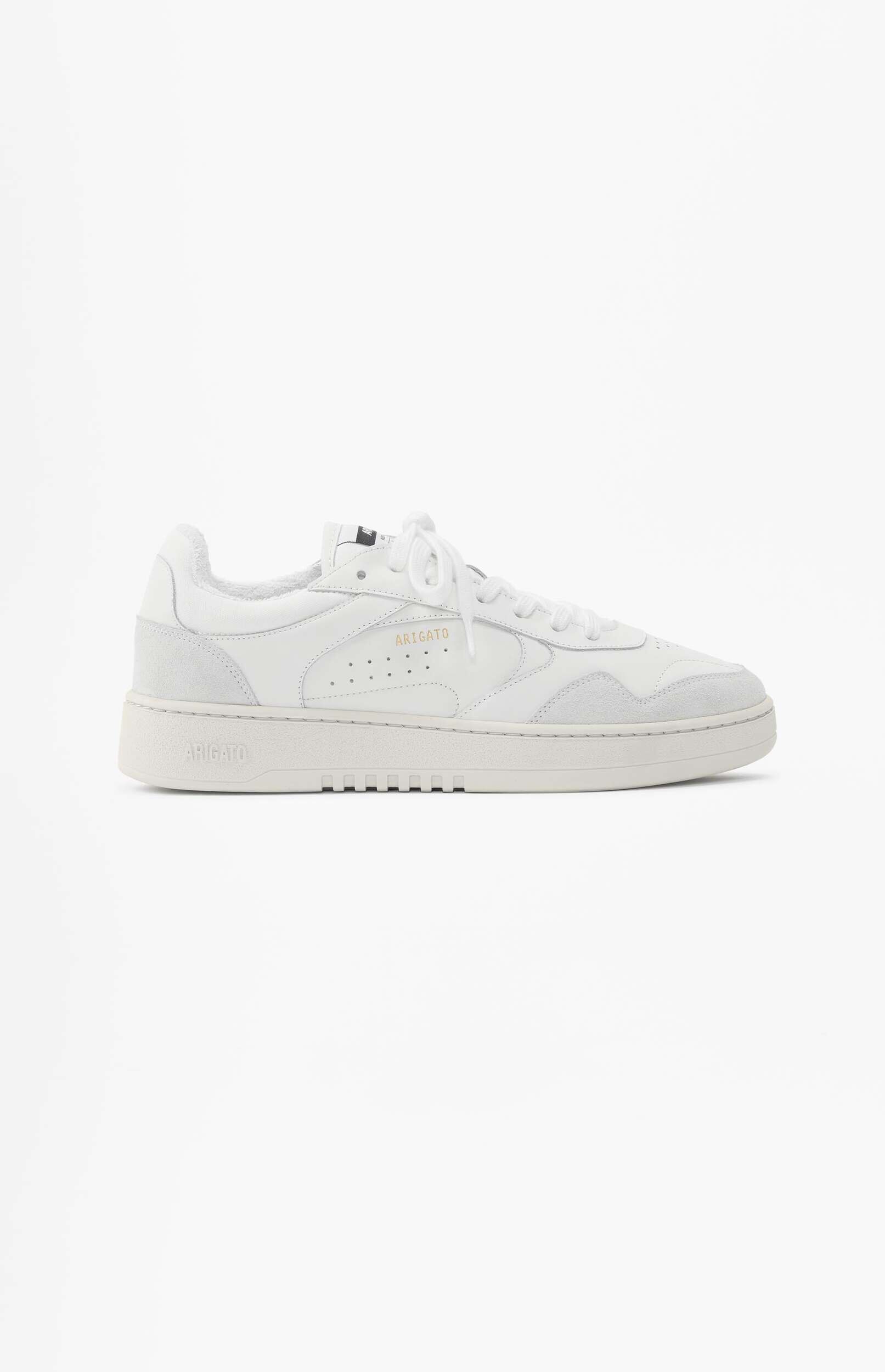A single white Axel Arigato Dice Lo sneaker, featuring light grey suede accents and white laces, displayed against a plain white background. The 'ARIGATO' brand name is visible in gold text on the side and embossed on the heel.