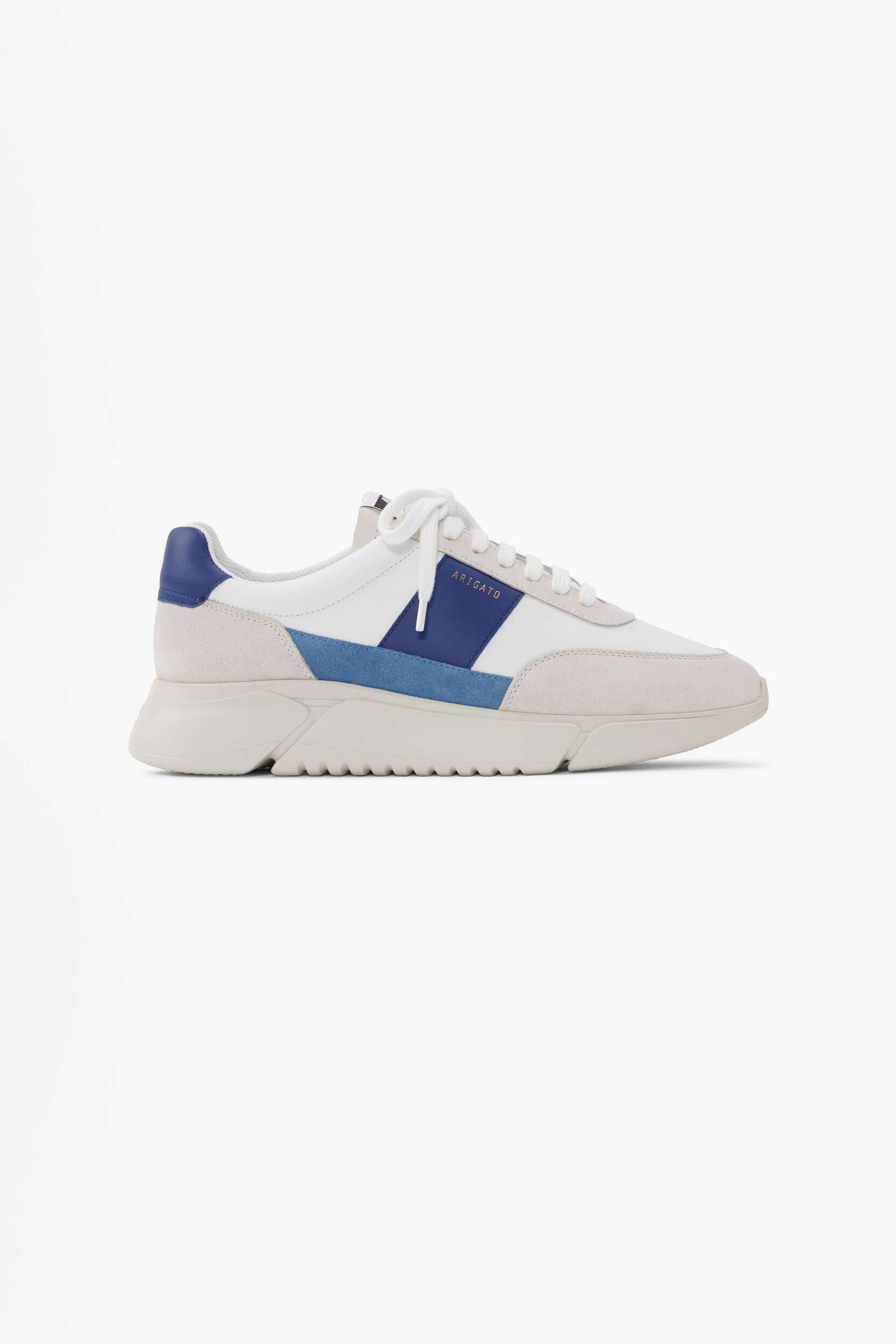 A white and light gray sneaker with blue and dark blue stripe accents on the side, featuring the brand name ARIGATO in gold lettering. The shoe has white laces and a chunky, light-colored sole, presented on a clean white background.