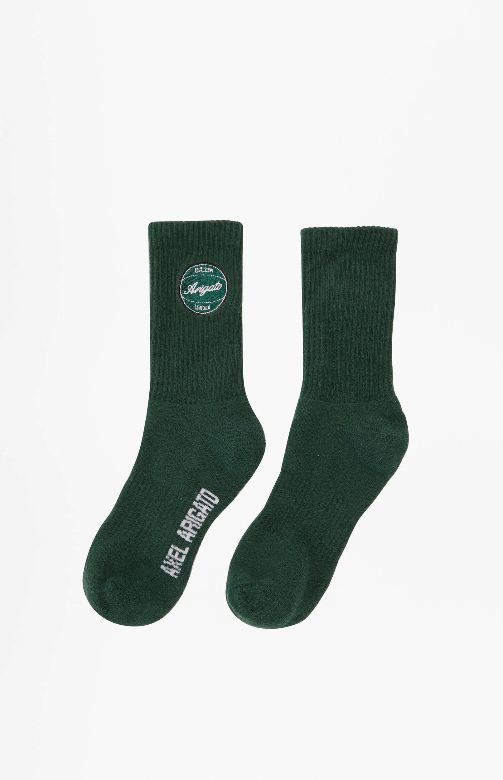 A pair of dark green ribbed socks from Axel Arigato are displayed on a white background. The left sock features a circular embroidered logo with 'Arigato' and 'London', while 'Axel Arigato' is vertically printed on the side of both socks.
