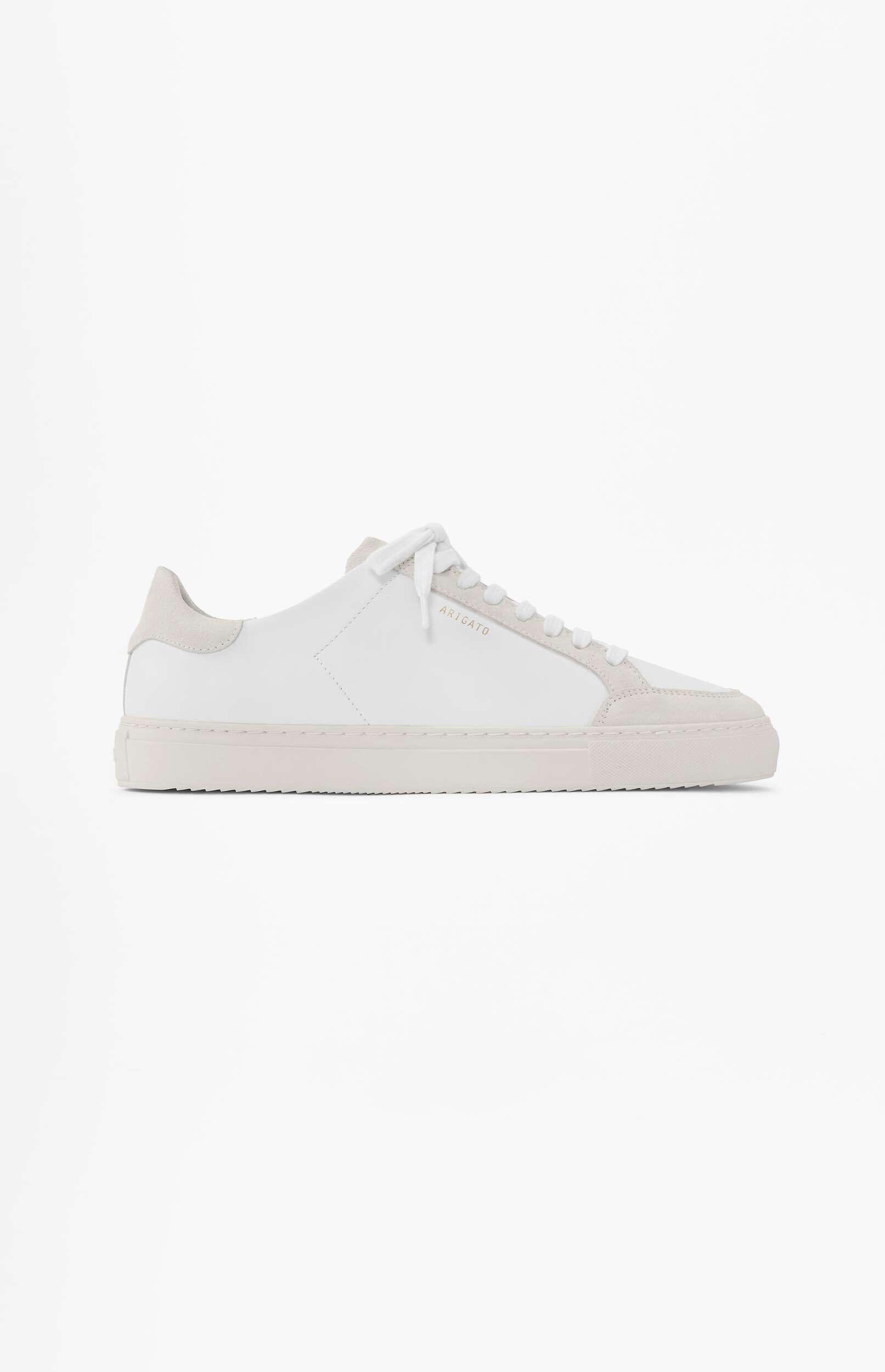 A white low-top ARIGATO sneaker with light gray suede details on the toe, sides, and heel, placed on a plain white background.