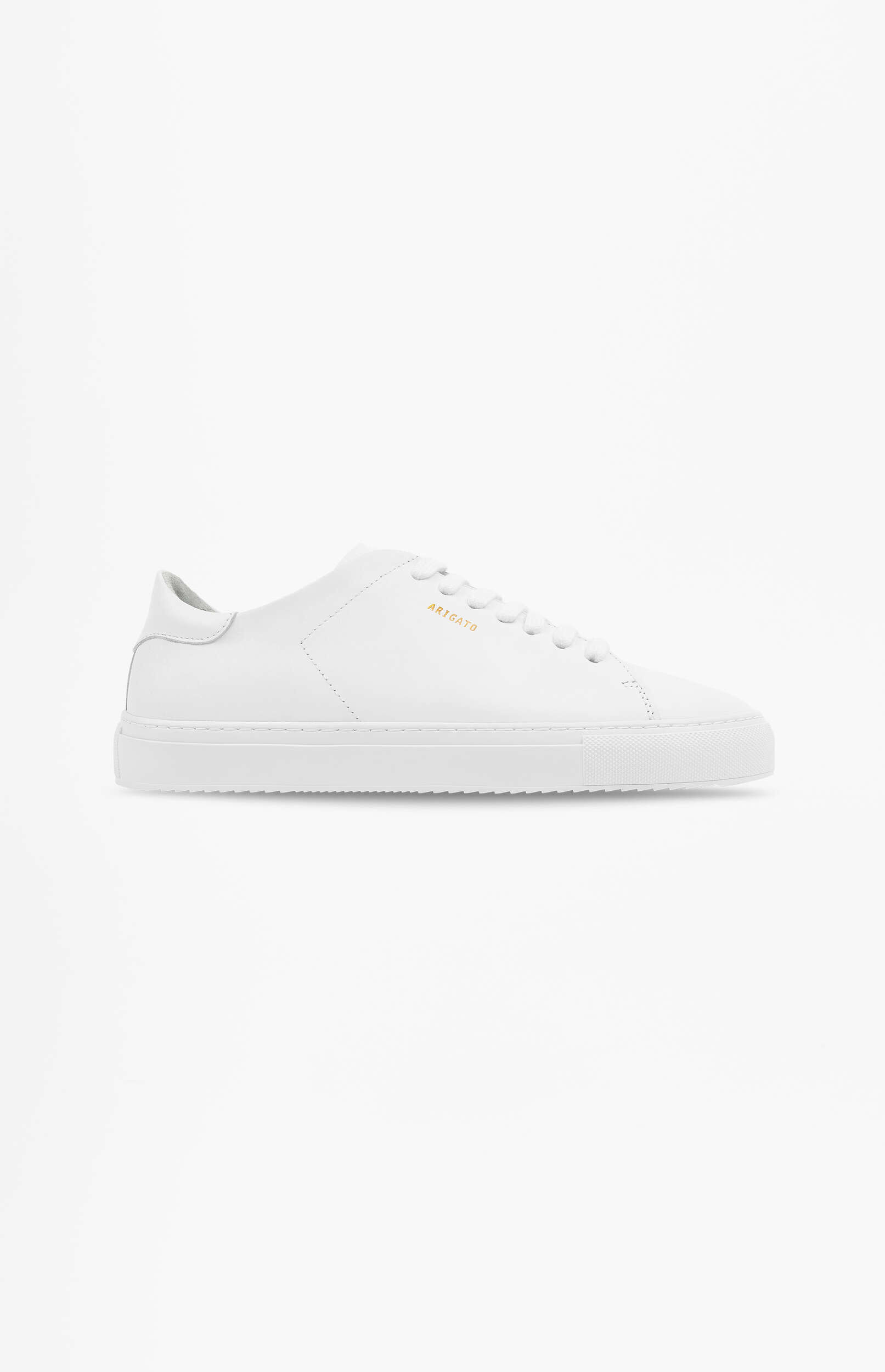 A single white leather sneaker with white laces and the brand name 'ARIGATO' in gold text on the side, displayed on a plain white background.