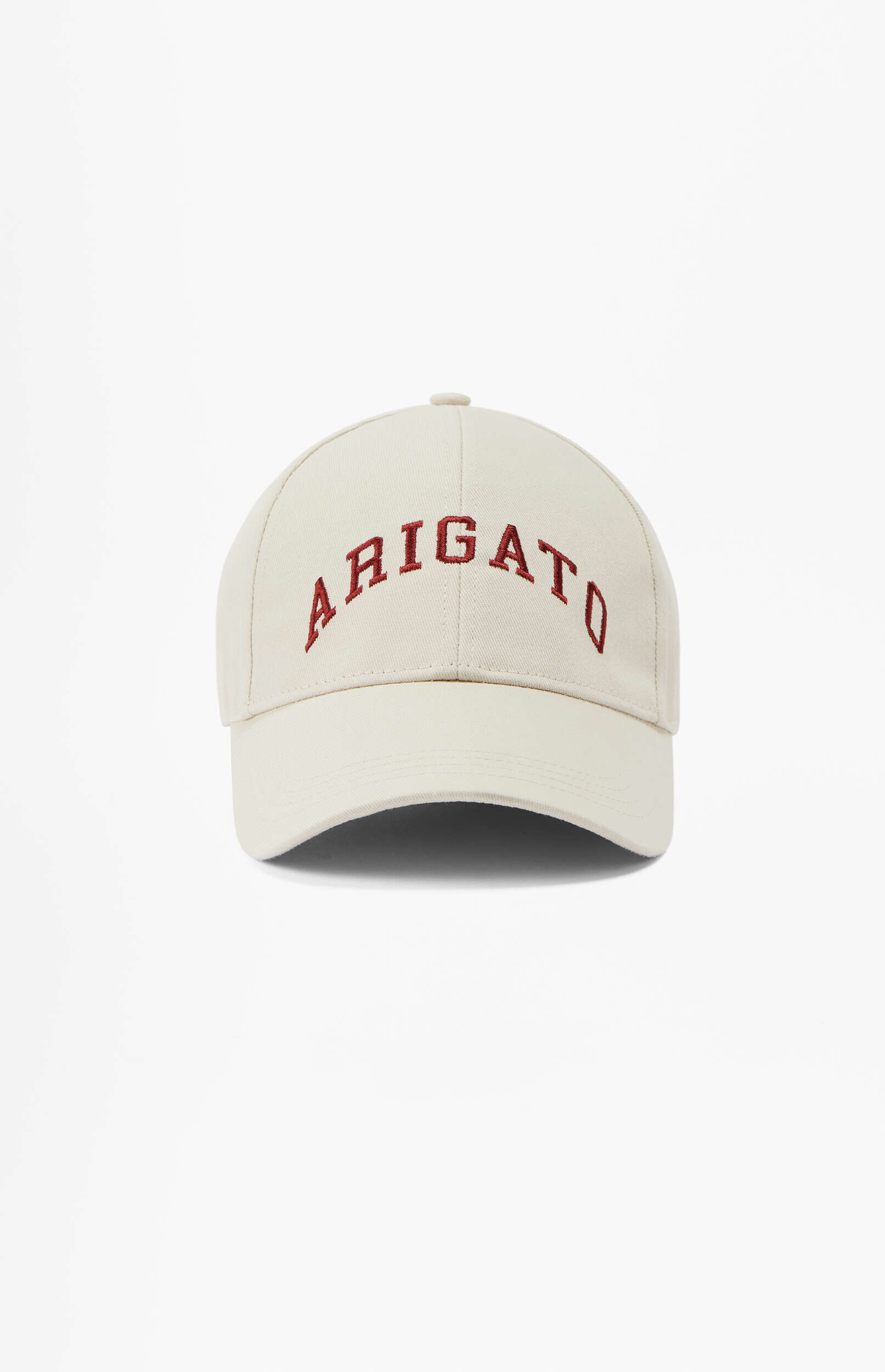 A light cream-colored baseball cap with the word ARIGATO embroidered in dark red letters on the front.