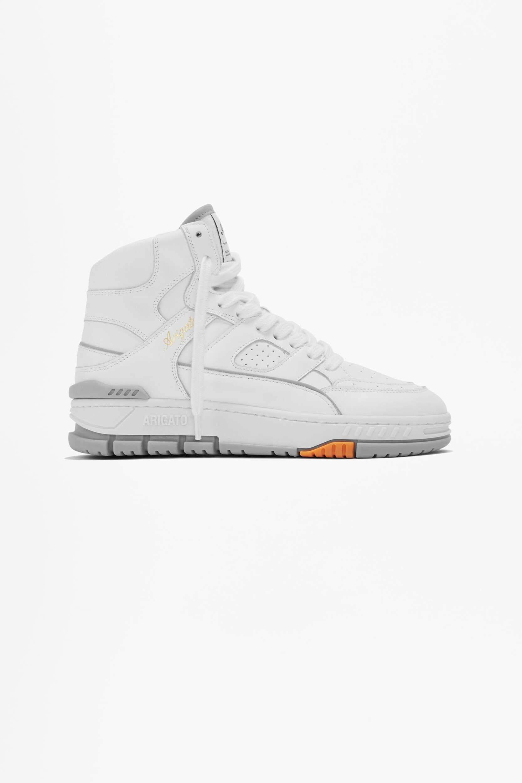 A white high-top Axel Arigato sneaker with grey accents on the sole and a small orange detail, shown against a plain white background.