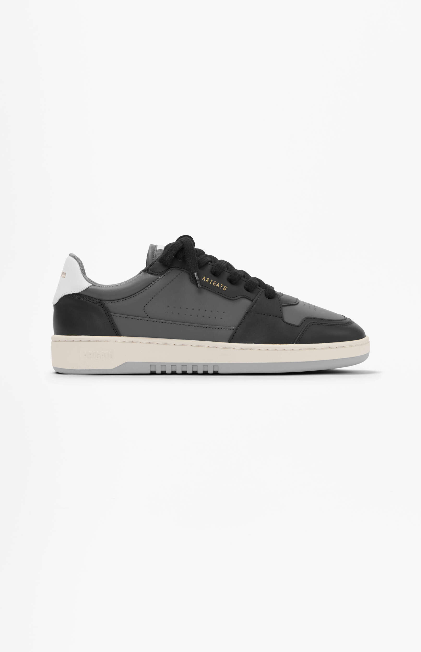 A side view of a dark grey and black Axel Arigato Clean 90 sneaker with black laces, a cream sole, and a white heel tab, presented on a clean white background.