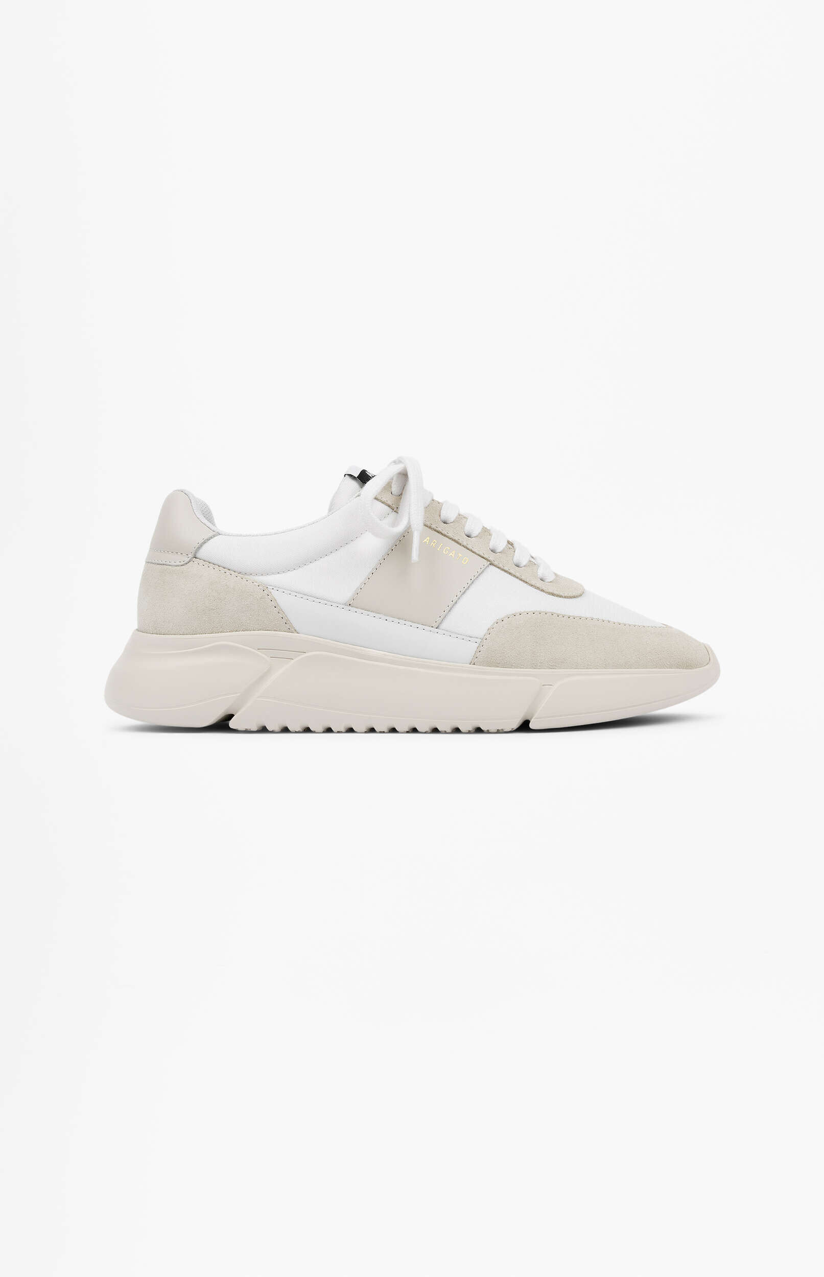 A single white and beige athletic sneaker with white laces and a thick ridged sole, displayed on a white background. The side of the shoe features the brand name 'ARIGATO' in subtle gold lettering.