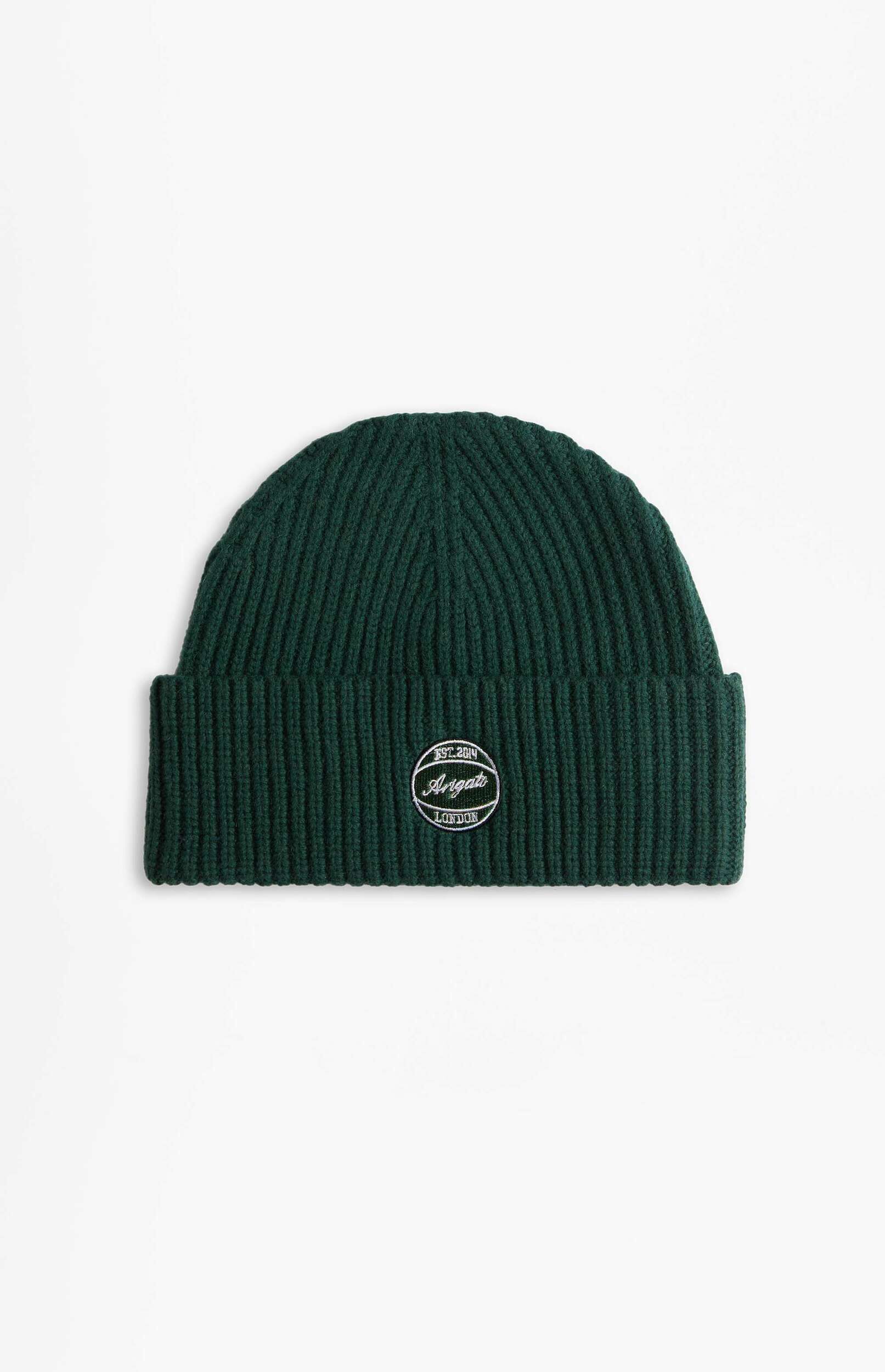 A dark green ribbed knit beanie hat with a white embroidered oval patch featuring 'EST. 2014', 'Arigato', and 'LONDON' text, set against a plain white background.