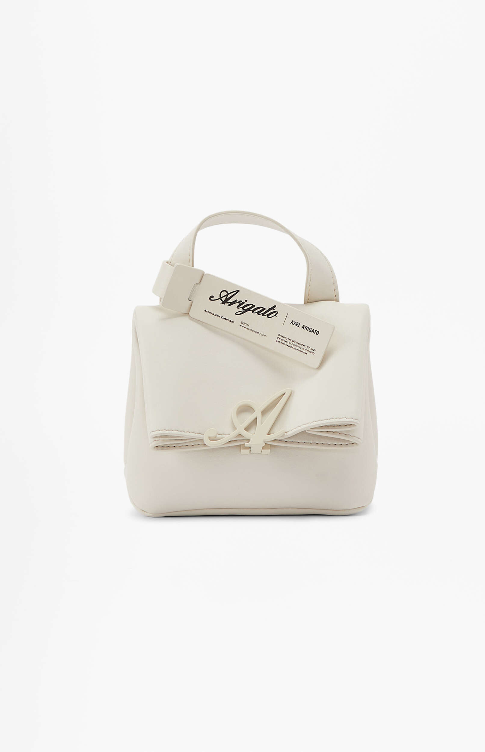 A cream-colored Axel Arigato handbag with a prominent stylized 'A' logo on the front flap and a hangtag displaying the brand name.