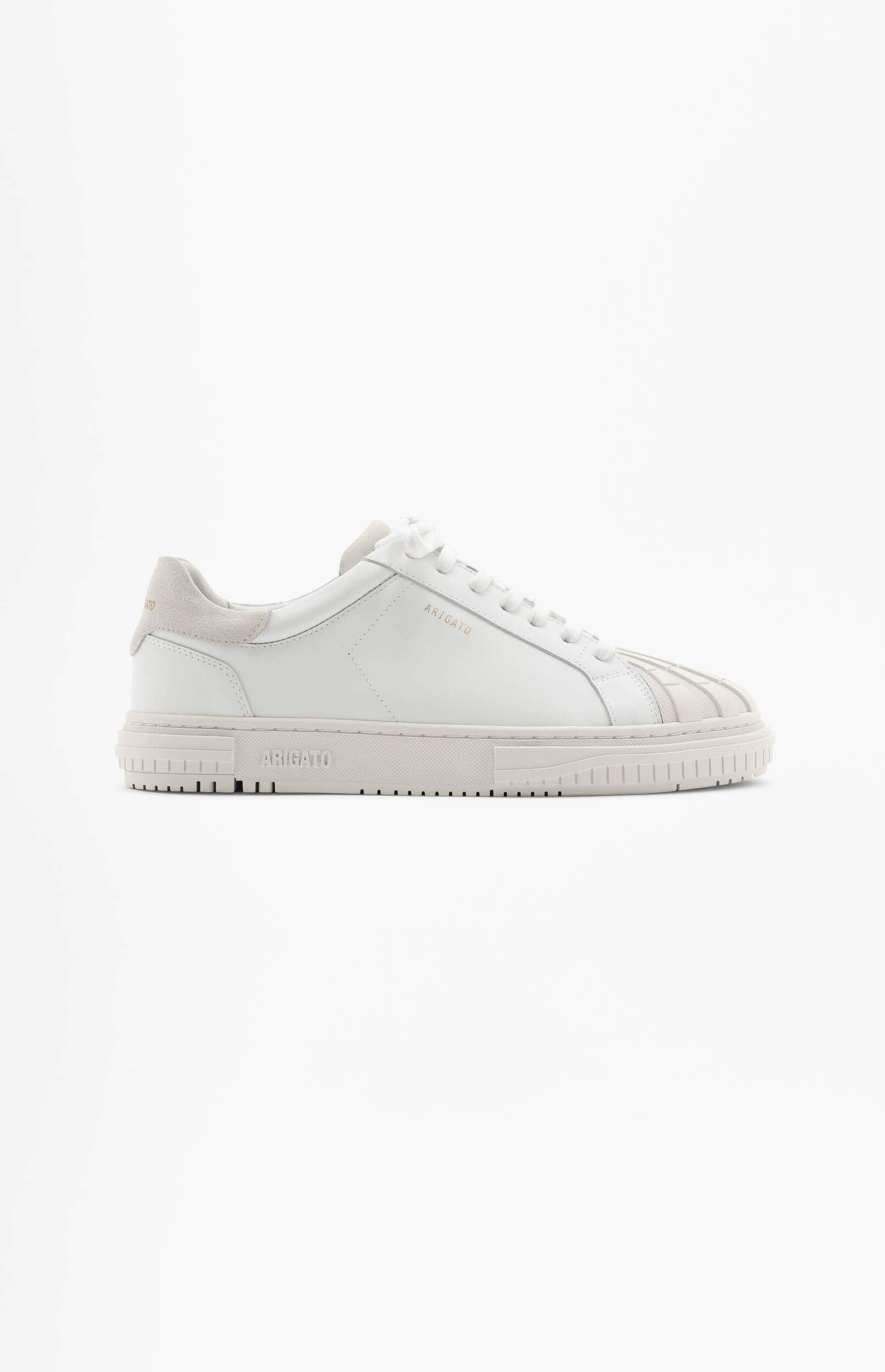 A white ARIGATO sneaker with light beige details on the heel tab, toe cap, and sole, presented on a minimalist white background.