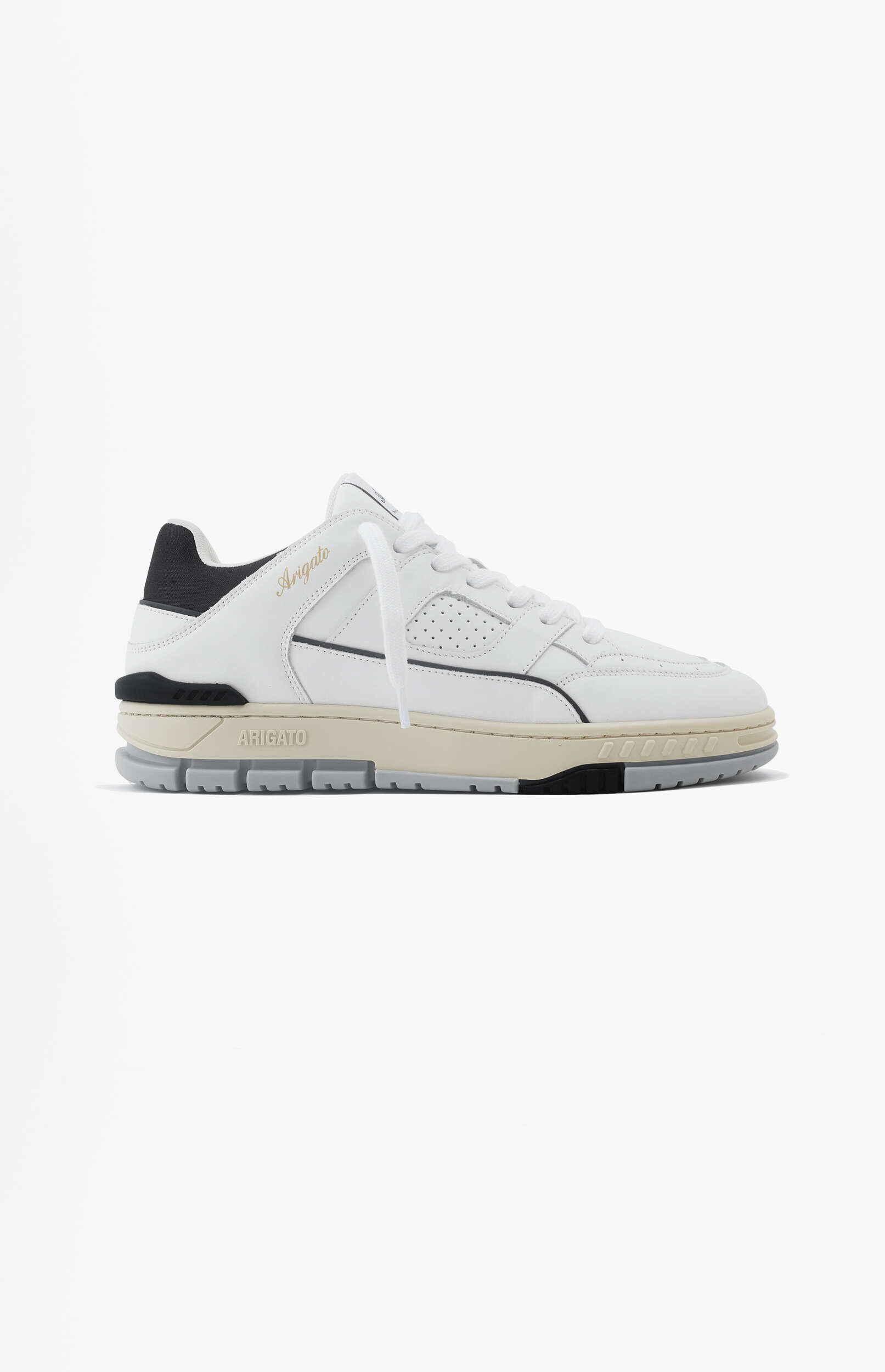 A white Axel Arigato low-top sneaker with black and beige accents, featuring white laces and a distinctive sole design, presented on a white background.