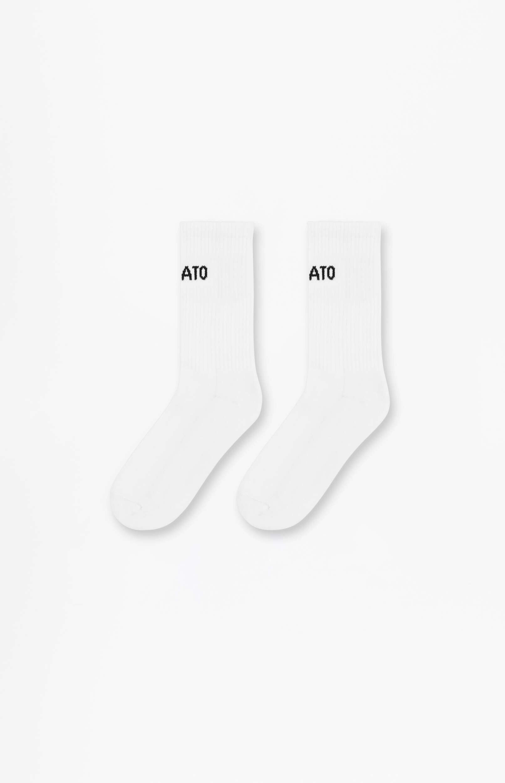 A pair of white crew socks with the black text 'ATO' printed on the ankle of each sock, displayed against a plain white background.