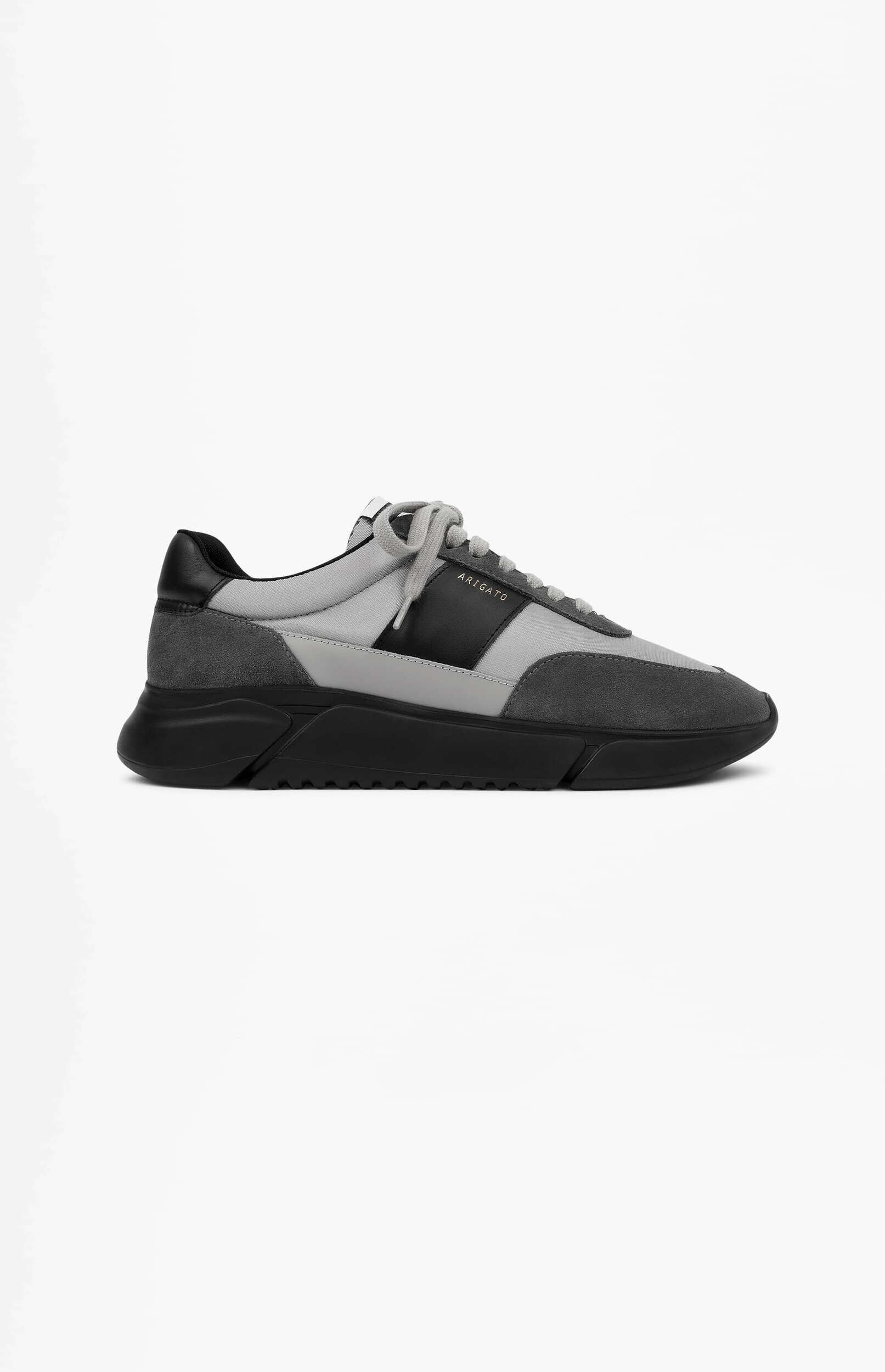 A single gray and black ARIGATO sneaker, featuring a light gray mesh upper with dark gray suede overlays and black leather accents, atop a chunky black sole, presented on a white background.