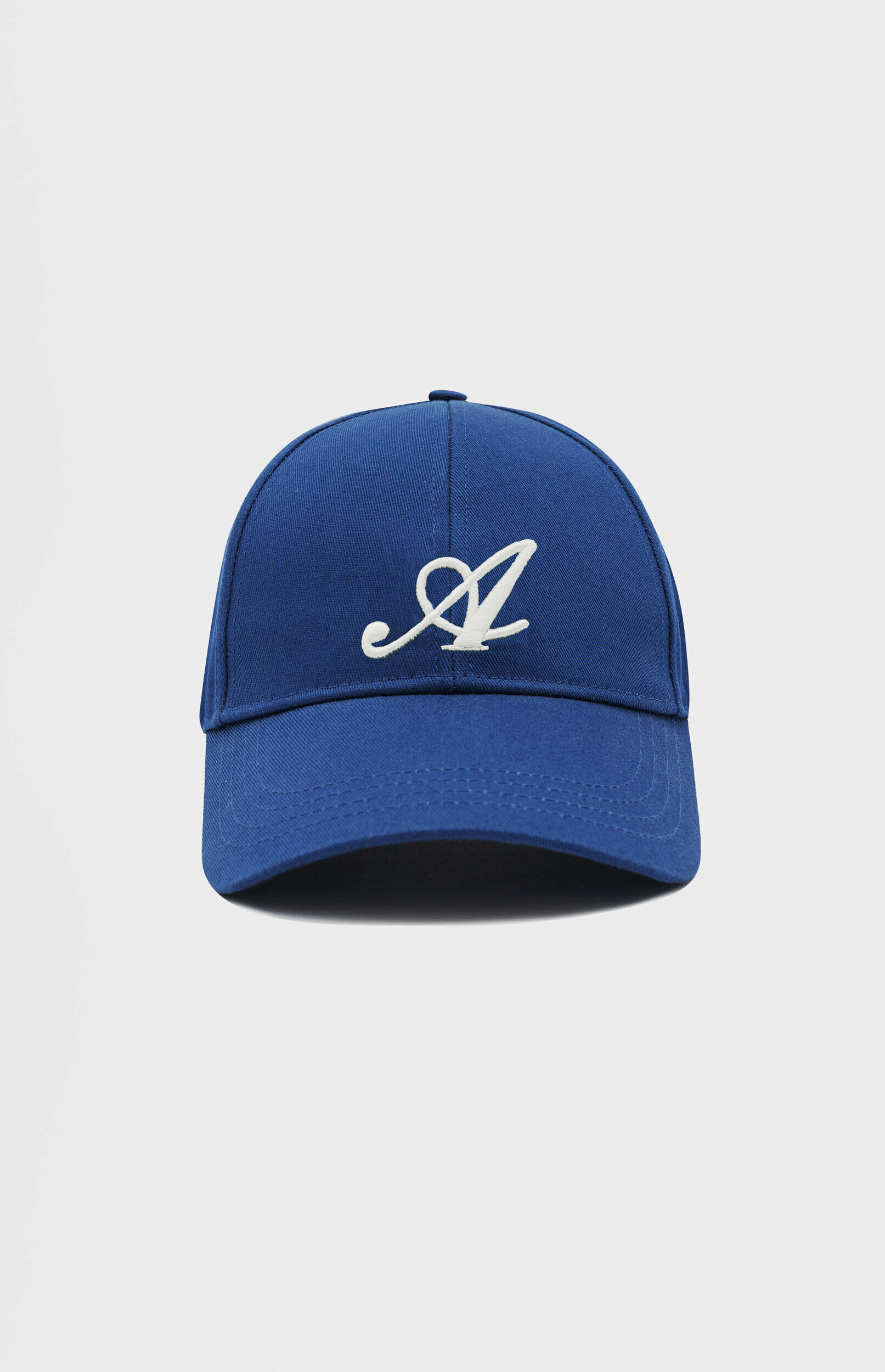 A royal blue baseball cap with a large, stylized white embroidered letter 'A' on the front, set against a plain light gray background.
